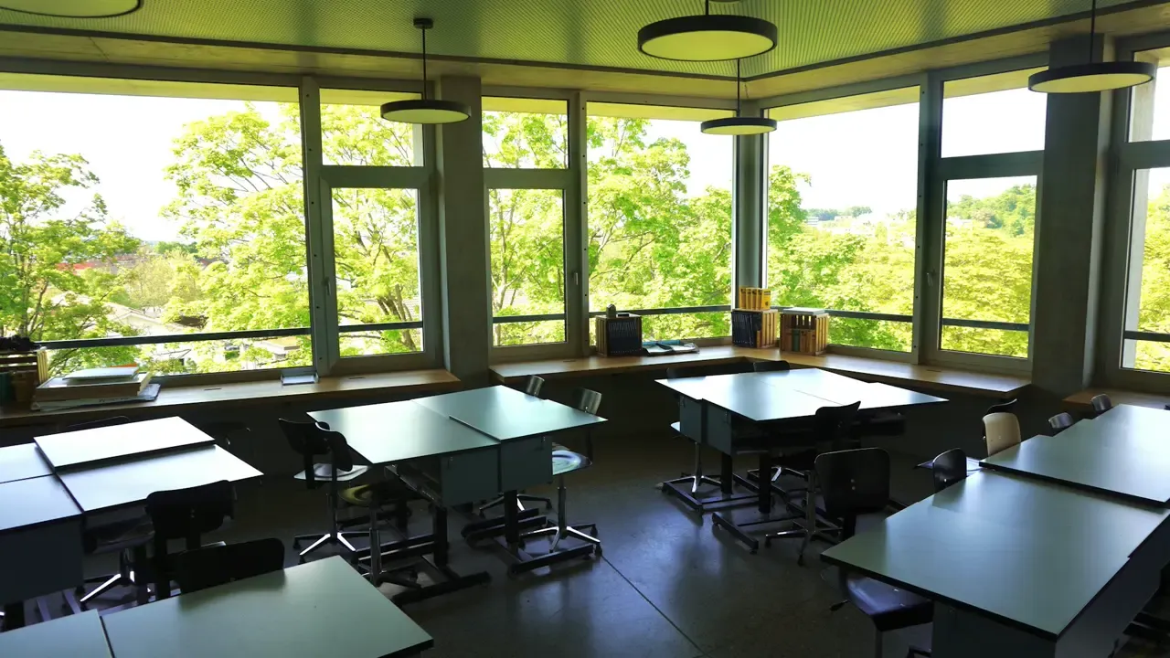 Sunlit classroom with desks and books, from QuillChannel’s existing course imagery.