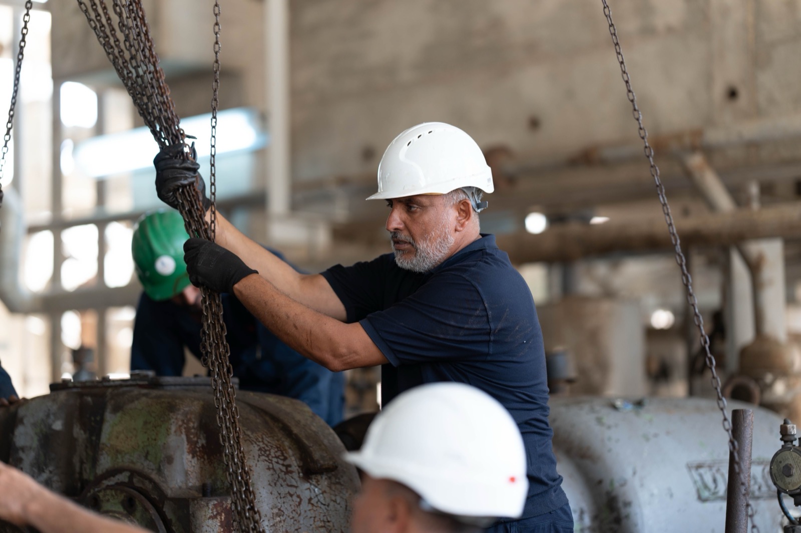 A field service technician logging a completed job on a phone at a work site